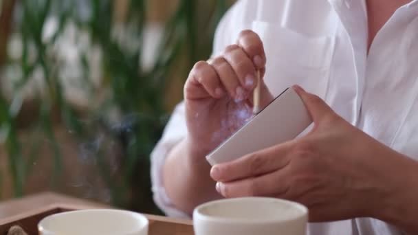 Woman lighting match, hold burning matchstick and a match box. Woman lights candles. Mental health, self care, No stress, healthy habit, mindfulness lifestyle, anxiety relief concept — Stock Video