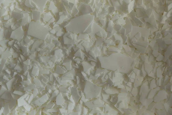 white soy wax flakes for candle making. Light texture of soy wax flakes. Ingredient for homemade candles. Ecological lifestyle