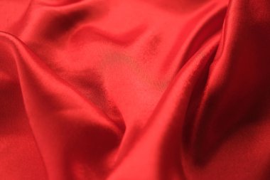 Örtülü kırmızı kadife arka planın soyut dokusu. Tekstil arka planı. Yakın plan. Üst görünüm