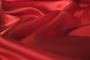 Örtülü kırmızı kadife arka planın soyut dokusu. Tekstil arka planı. Yakın plan. Üst görünüm