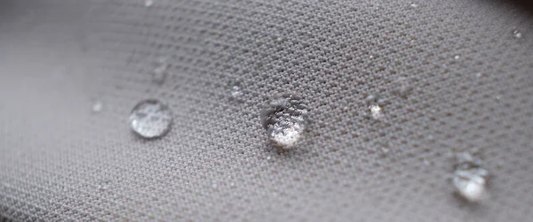 water beading on fabric. Waterproof coating background with water drops. soft focus, blur