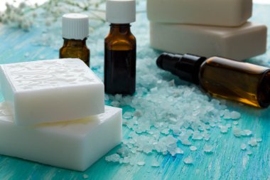 doğal organik sabun şişe esans ve mavi ahşap bir masa Spa üzerinde deniz tuzu 