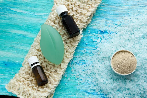 Natural organic soap bottles essential oil and sea salt herbal bath  on a blue wooden table — Stock Photo, Image