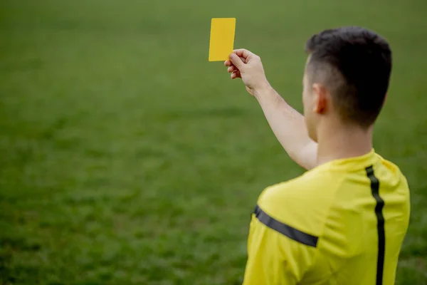 Referee showing a red card to a displeased football or soccer player while gaming. Concept of sport, rules violation, controversial issues, obstacles overcoming