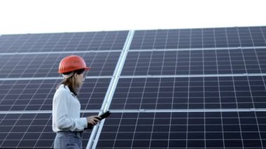 Güneş panellerinin yanında duran genç ve güzel mühendis, Yeşil Enerji Konsepti