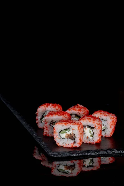 Filadelfia rollo con salmón, queso y pepino sobre un fondo negro con reflejo. Sushi Filadelfia —  Fotos de Stock
