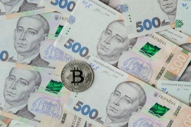 Ukrayna Hryvnia 'sının arka planına karşı Bitcoin.