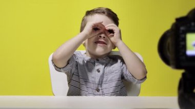 Çocuk blogcu video bloğunu evde kaydediyor. Çocuk video blogunu kaydediyor. Küçük vlogger kamera kullanarak çevrimiçi yayın yapıyor