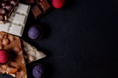 Çikolata arkaplanı. Çikolata. Beyaz, siyah ve sütlü çikolataların karışımı. Çikolatalı Praline tatlılar..