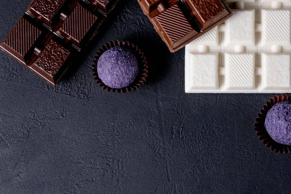 Chocolates background. Chocolate. Assortment of fine chocolates in white, dark, and milk chocolate. Praline Chocolate sweets.