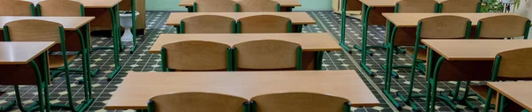 selective soft and blur focus.old wooden row lecture chairs in classroom in poor school.study room without student.concept for education.