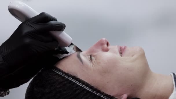 Kosmetolog, kosmetolog, ansiktsbehandling med ultraljud spatel — Stockvideo