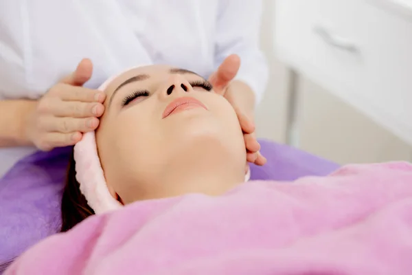 Face massage. Close-up of young woman getting spa massage treatment at beauty spa salon.Spa skin and body care. Facial beauty treatment.Cosmetology