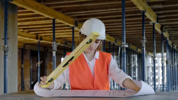 Architect or engineer working, browsing building project indoor of construction site with blueprint plan. Woman construction engineers or architects working people — Stock Video