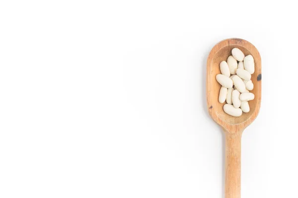 Frijoles blancos en una cuchara en fondo blanco. Phaseolus vulgaris —  Fotos de Stock