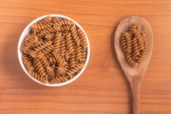 Wholemeal Fusilli into a bowl. Integral Pasta — Stock Photo, Image