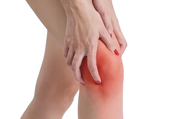 Woman holding her knee in pain, with red highlighted on pain area on a white background — Stock Photo, Image