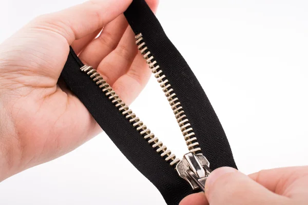 Hand holding zipper — Stock Photo, Image