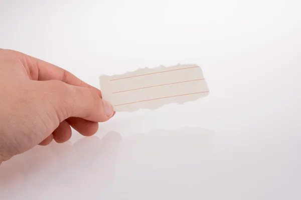 Pedaço de papel forrado na mão — Fotografia de Stock