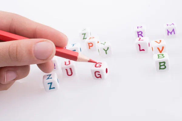 Letter cubes and red pencil — Stock Photo, Image