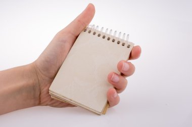 bir defter tutan el