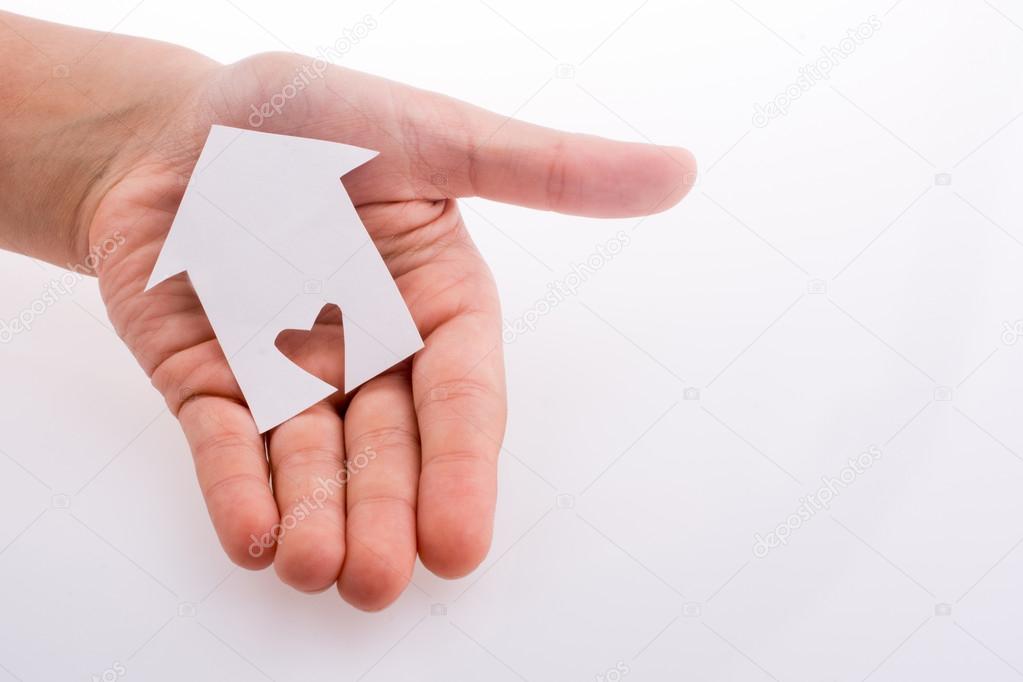Hand holding a paper house