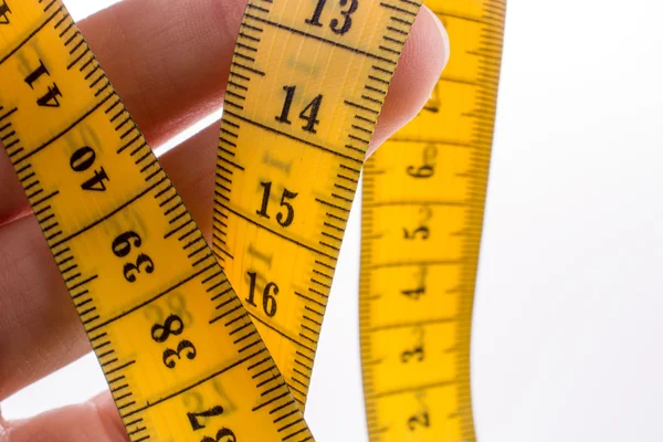 Measuring tape in hand — Stock Photo, Image