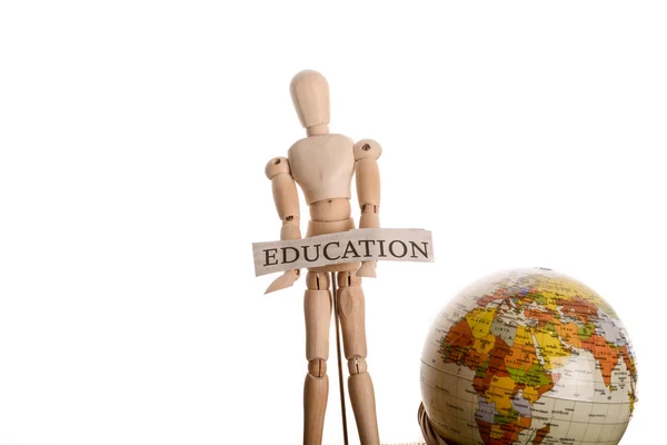 Wooden man holding education sign and globe — Stock Photo, Image