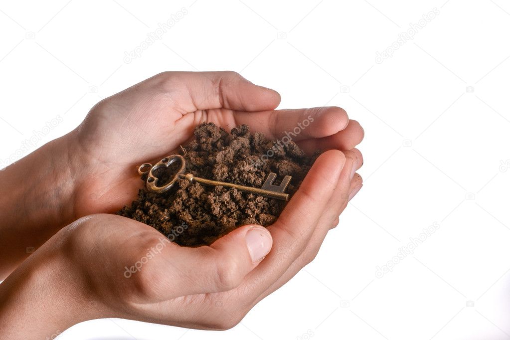 key in handful soil 
