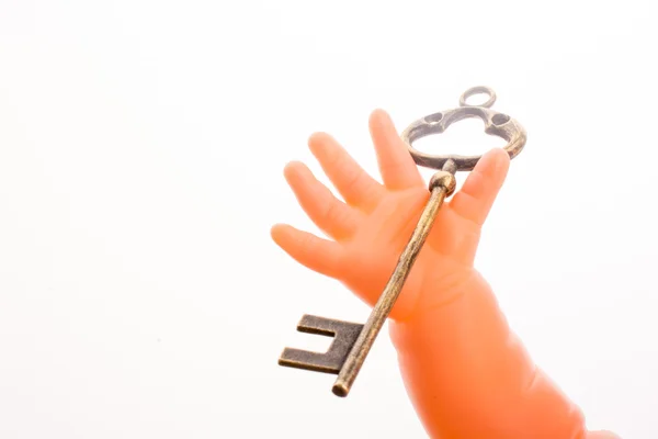 Boneca segurando uma chave — Fotografia de Stock