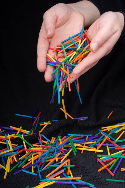 Hand Letting Coloured Wooden Sticks Fall Black Background — Stock Photo, Image