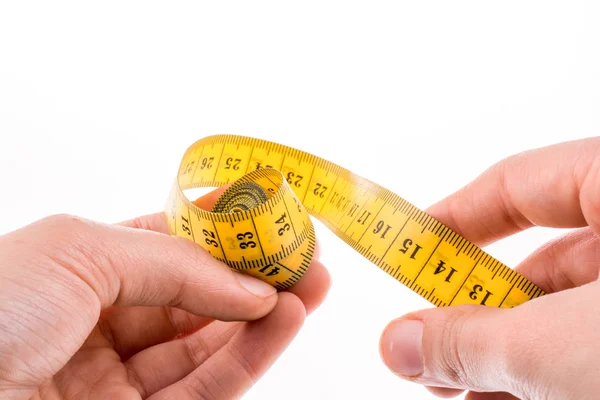 Measuring tape in hand — Stock Photo, Image