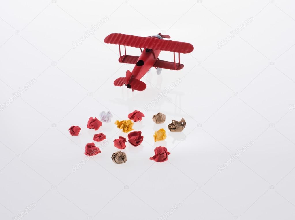 Red airplane and crumpled paper