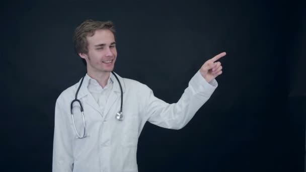 Positive doctor looking into camera, pointing on items. Thumbs up. Packshot. — Stock Video