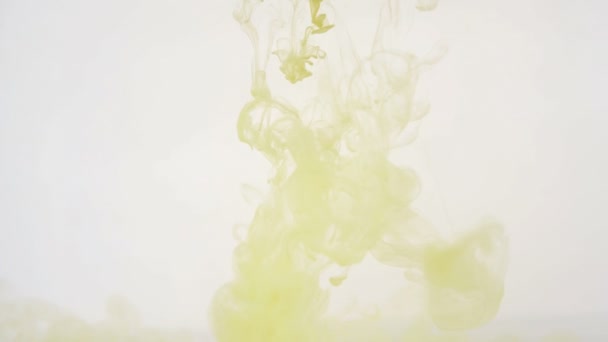 Colourfull background. Yellow ink dropped in water. Slow motion. — Stock Video