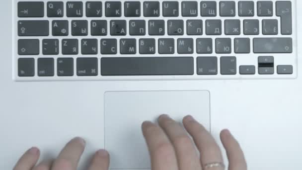 Top view of laptop computer keyboard and touch-pad used by male hands. Close up. — Stock Video