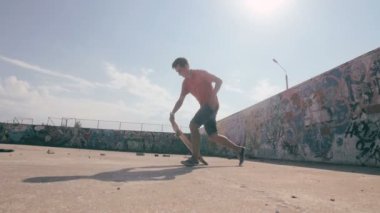 Bir şehir paten parkta atlama kaykaycı. Skow hareket. Steadicam ateş.