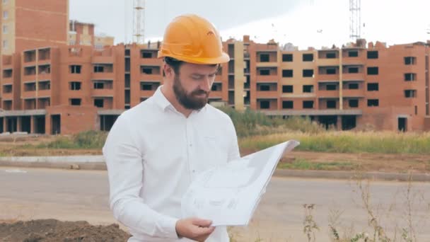 Professional engineer, constructor at work in construction site, looking at camera. Portrait. — Stock Video