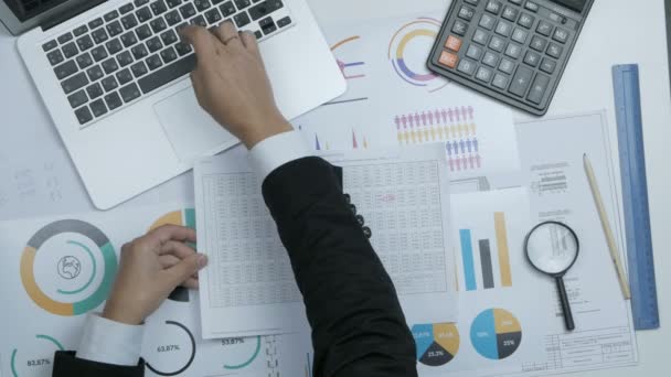 Financial specialist, businessman working with blueprint, graph at his workplace. — Stock Video