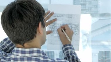 Modern bir ofis planı üzerinde çalışan mühendis.