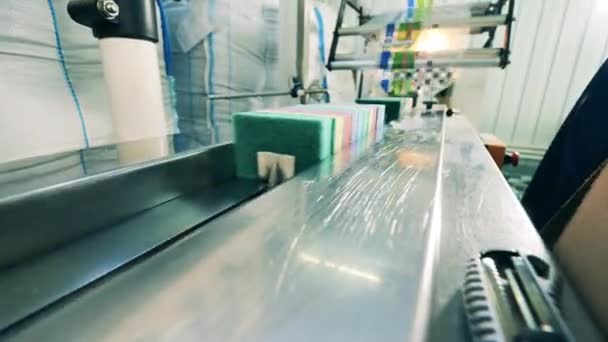 Batches of kitchen sponges are getting put onto the conveyor — Stock Video