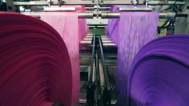 Reels with polyethylene wrapping paper rolling through them. Polyethylene production factory conveyor. — Stock Video