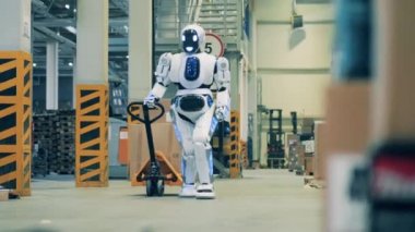 Depo robotu karton kutularla dolu bir arabayı çekiyor.