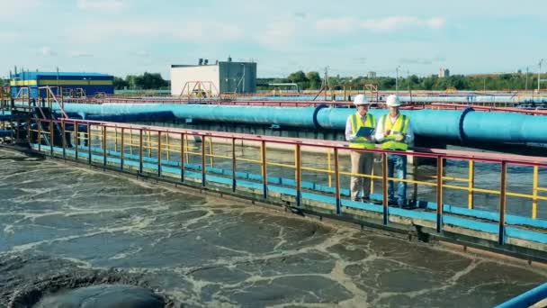 Wastewater treatment site with two technicians — Stock Video