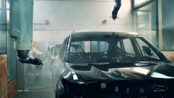 Cuerpo de coche pintado de negro por brazos robóticos — Vídeos de Stock