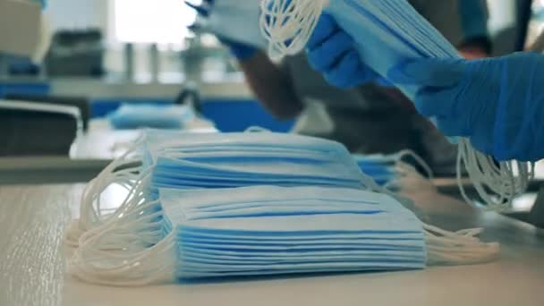 Medical masks are getting put into batches in a close up — Stock Video