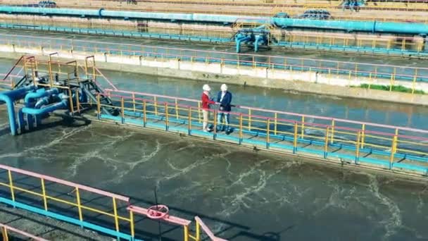 Dos especialistas discuten una gran instalación de limpieza de aguas residuales — Vídeos de Stock