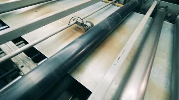 Metal sheet moving through rollers at metal working factory — Stock Video