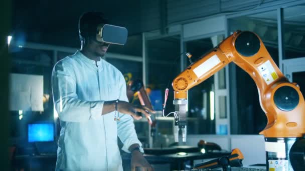 Robot sedang dinavigasi oleh seorang peneliti Afrika di VR-gelas — Stok Video