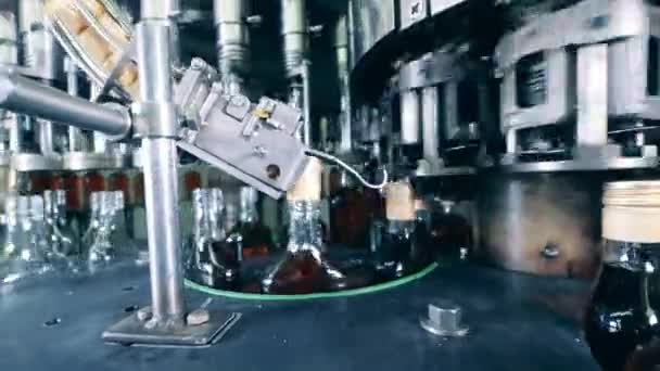 Factory mechanism with bottles of cognac being relocated by it — Stock Video